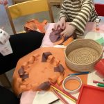 Child making lion craft at Play B C Preschool.